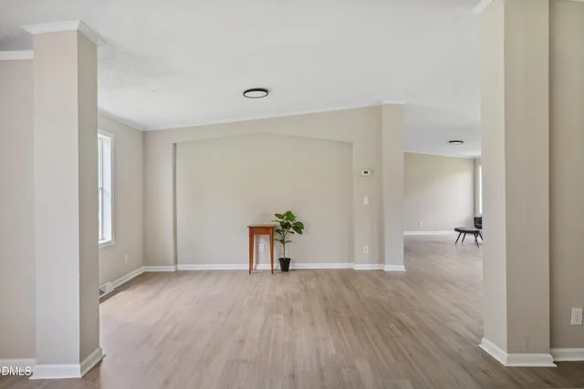 a view of empty room with wooden floor