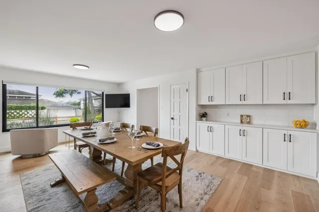 a dining room with furniture and wooden floor