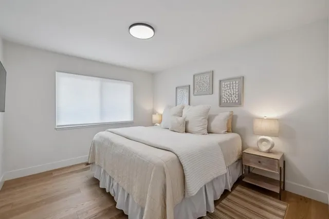 a bedroom with a bed and a lamp