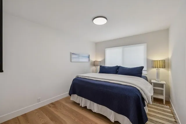 a bathroom with a toilet a sink a mirror and vanity