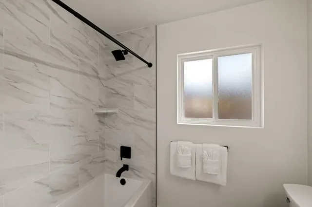 a bedroom with a bed and a night stand