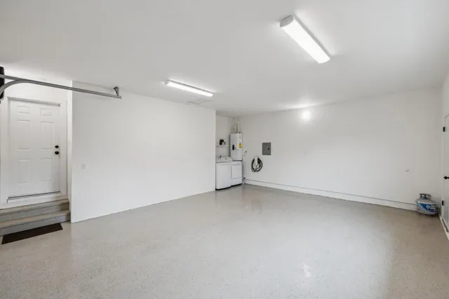 a open dining room with kitchen island a table and chairs in it
