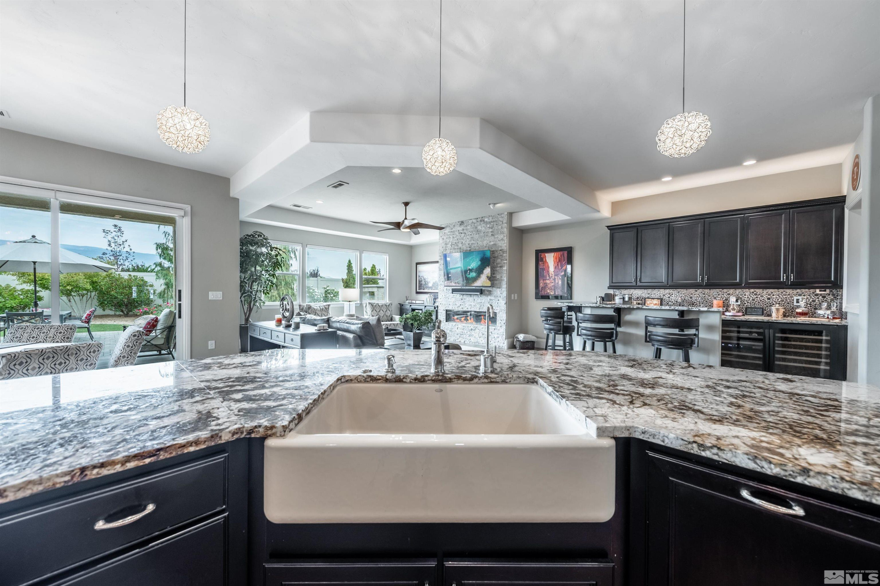 9815 Dyevera Lane Reno, NV 89521 - Photo 11 of 39 a kitchen with stainless steel appliances granite countertop a sink a stove and a wooden cabinets