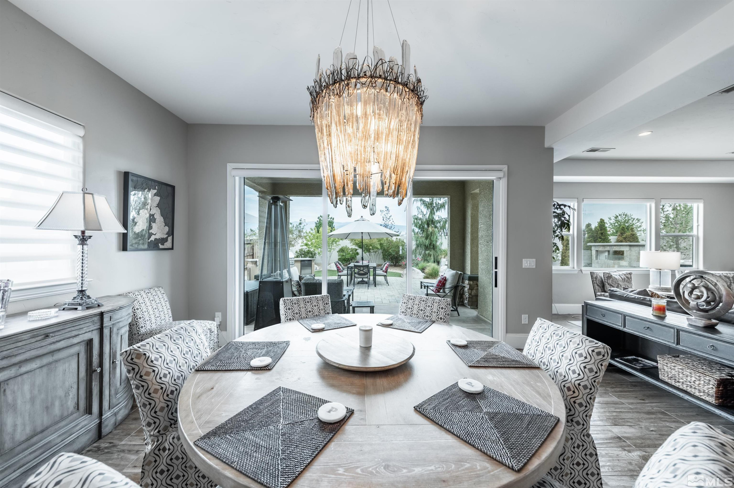 9815 Dyevera Lane Reno, NV 89521 - Photo 13 of 39 a living room with furniture and a chandelier