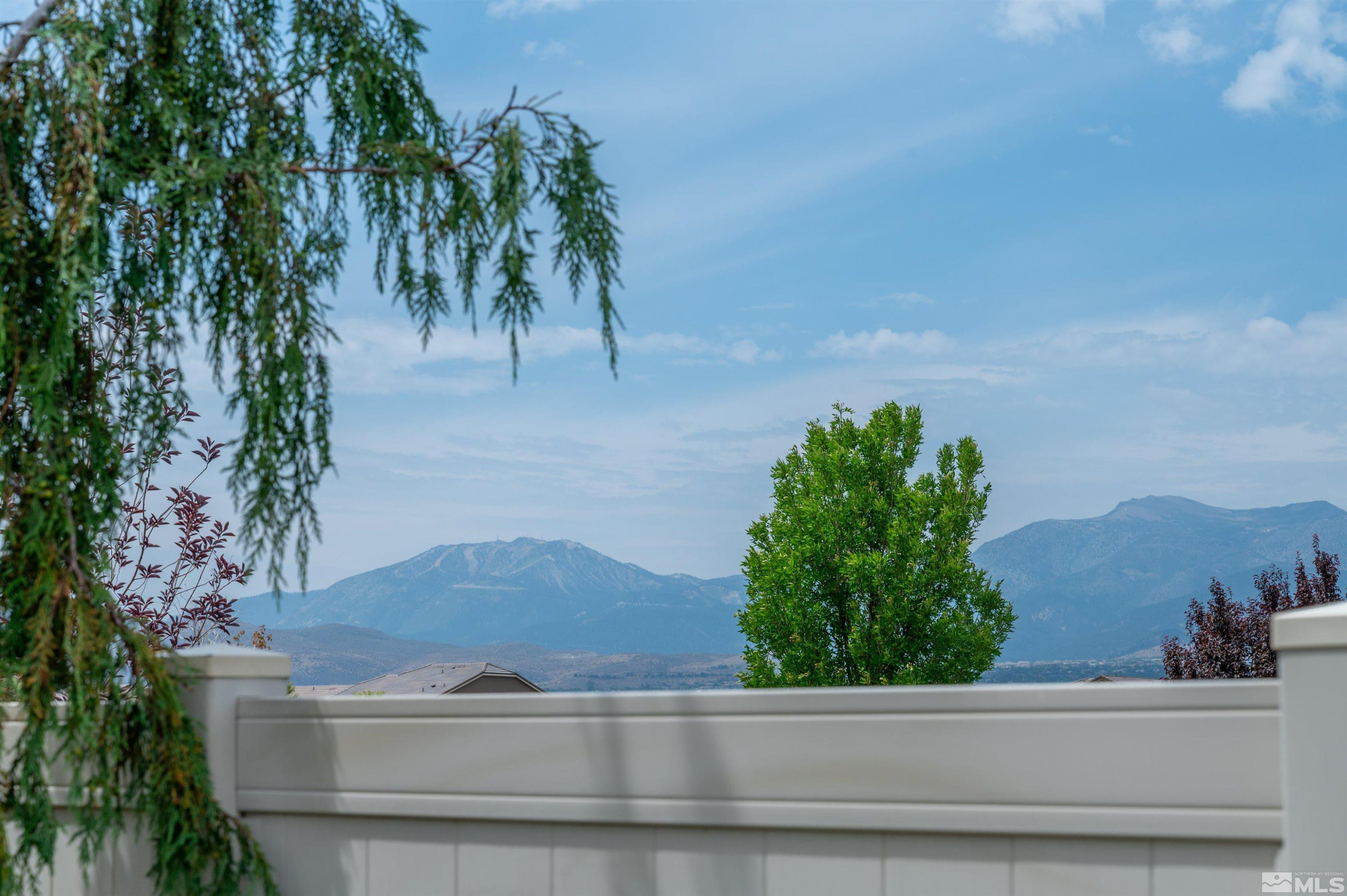 9815 Dyevera Lane Reno, NV 89521 - Photo 17 of 39 a white house with a trees in the background