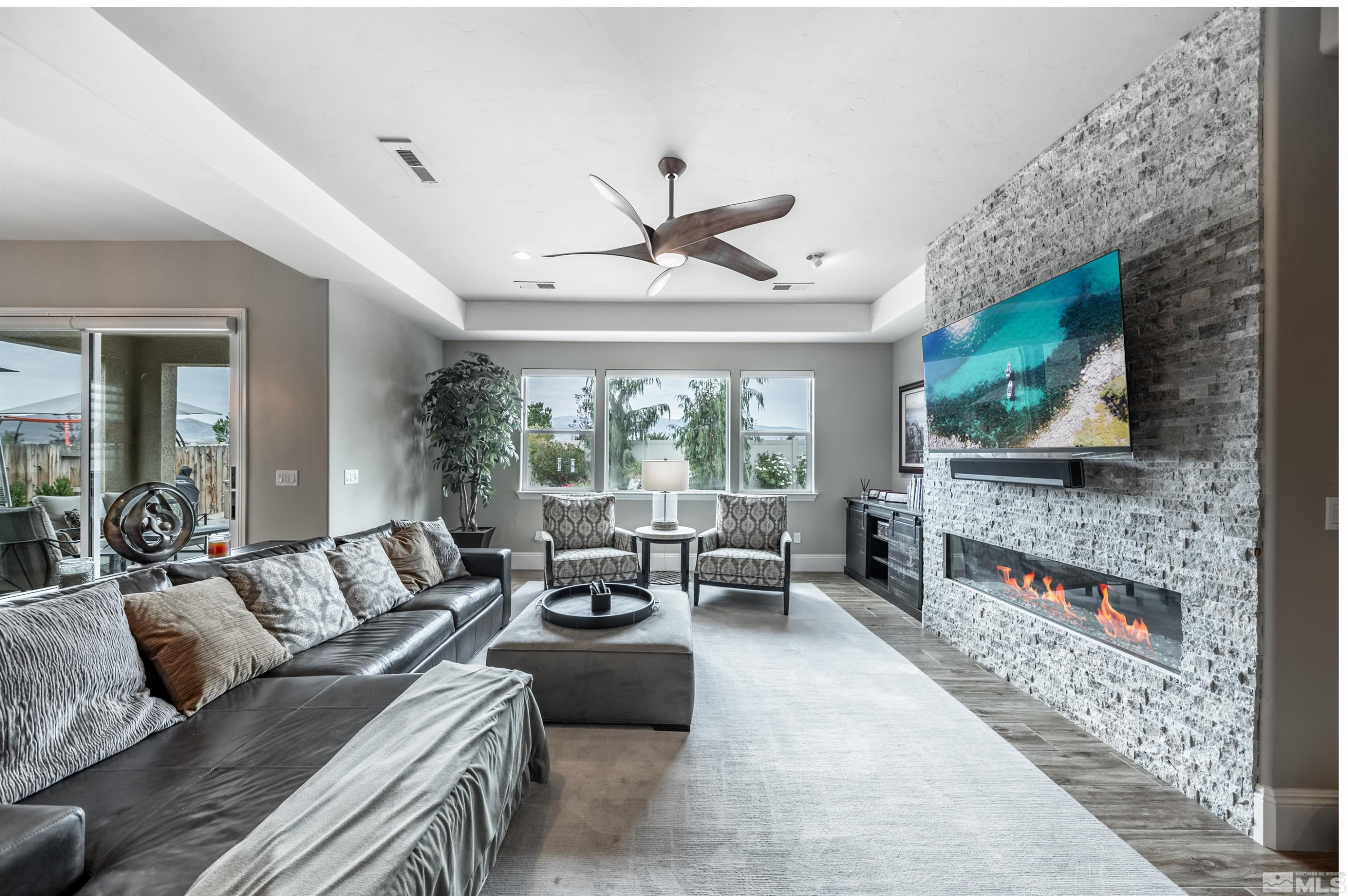 9815 Dyevera Lane Reno, NV 89521 - Photo 21 of 39 a living room with furniture and a flat screen tv