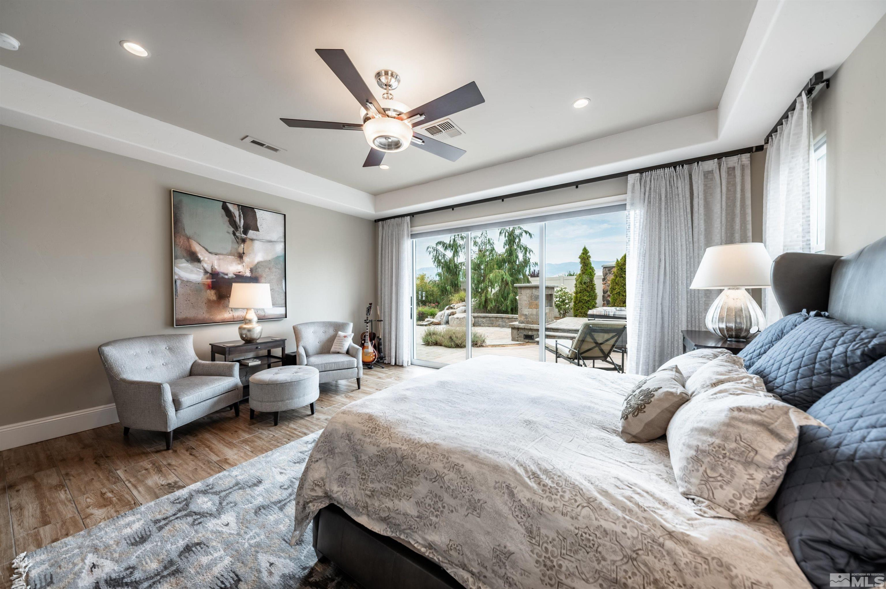 9815 Dyevera Lane Reno, NV 89521 - Photo 23 of 39 a bedroom with a bed and glass window