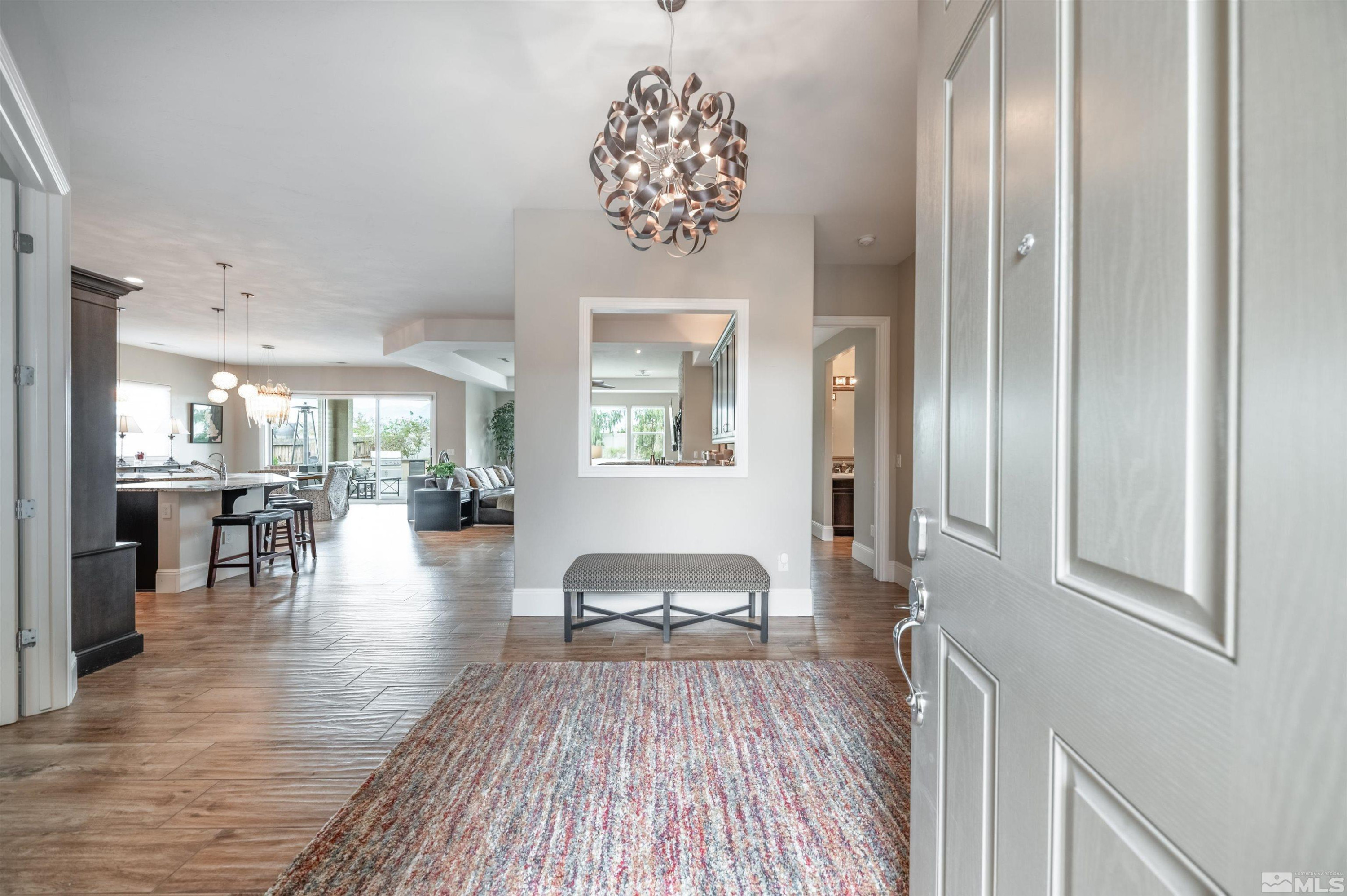9815 Dyevera Lane Reno, NV 89521 - Photo 4 of 39 a living room with furniture and a chandelier