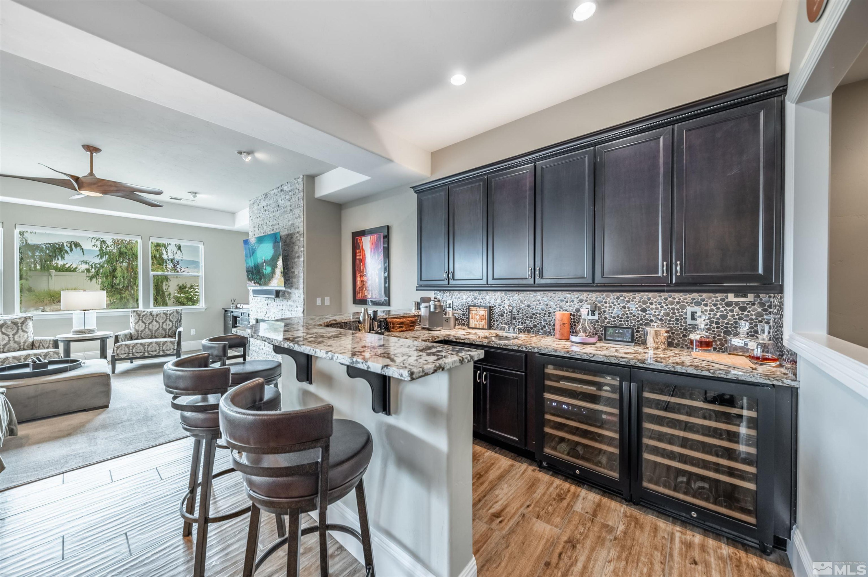 9815 Dyevera Lane Reno, NV 89521 - Photo 5 of 39 a kitchen with sink refrigerator dining table and chairs