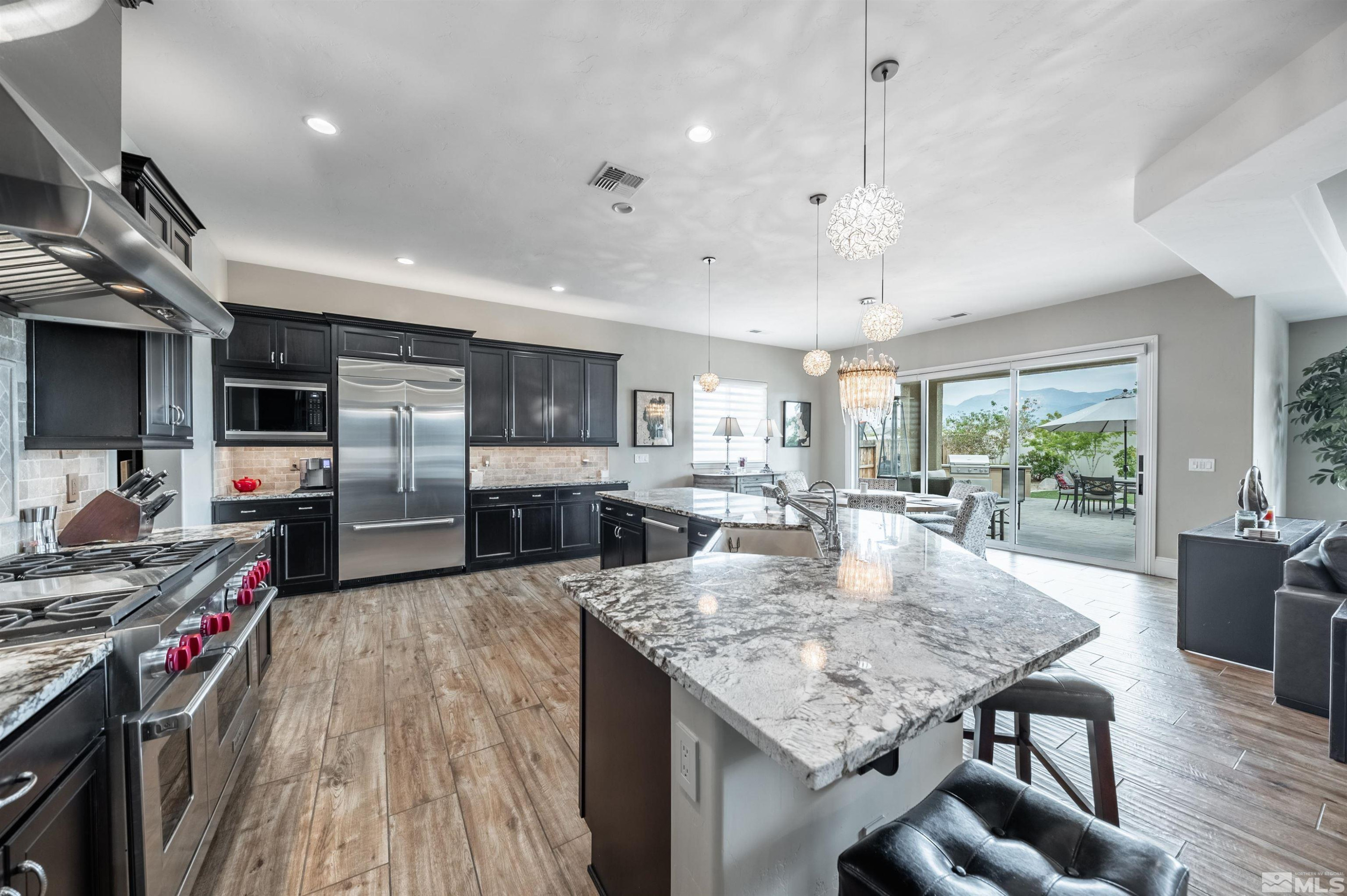 9815 Dyevera Lane Reno, NV 89521 - Photo 8 of 39 a kitchen with stainless steel appliances granite countertop a stove oven and a refrigerator with white cabinets