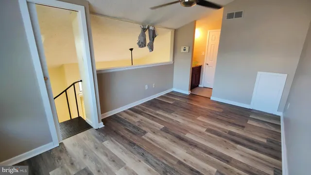 a view of a room with wooden floor and stairs
