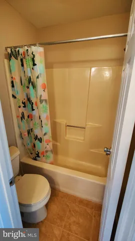 a bathroom with a toilet and shower