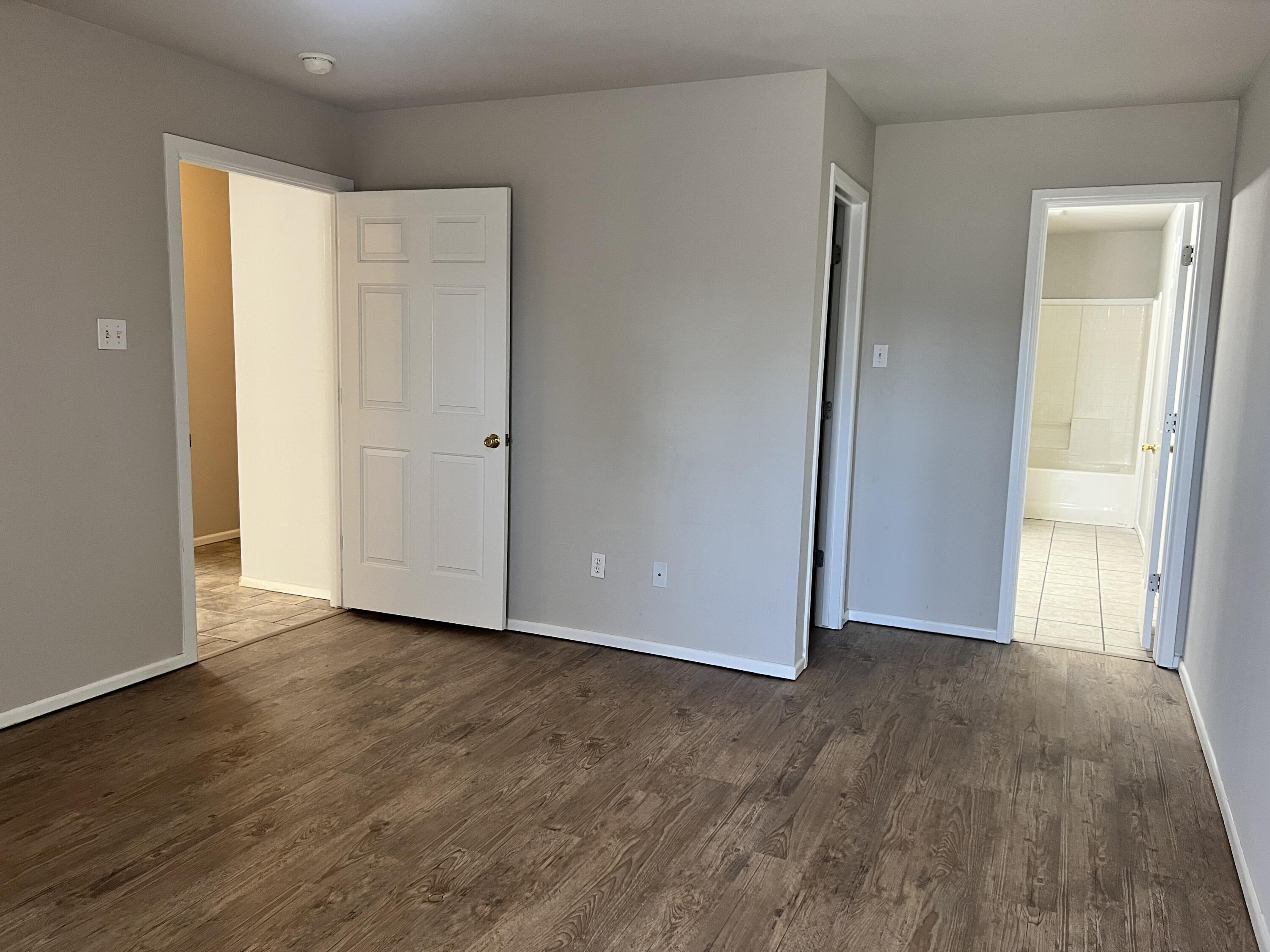 3415 49th Street, Unit B Lubbock, TX 79413 - Photo 12 of 17 a view of an empty room and wooden floor