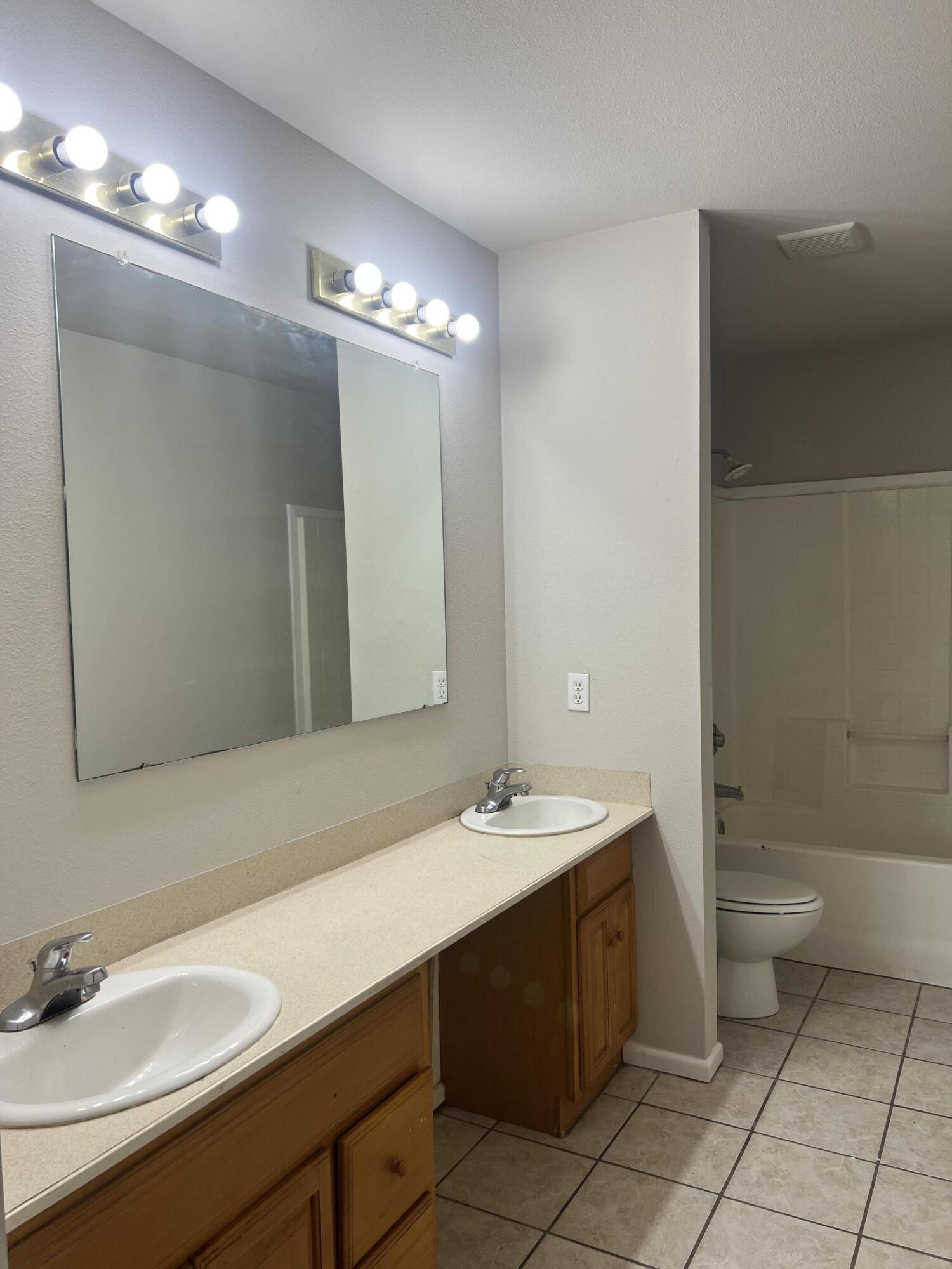 3415 49th Street, Unit B Lubbock, TX 79413 - Photo 14 of 17 a bathroom with a sink double vanity and toilet