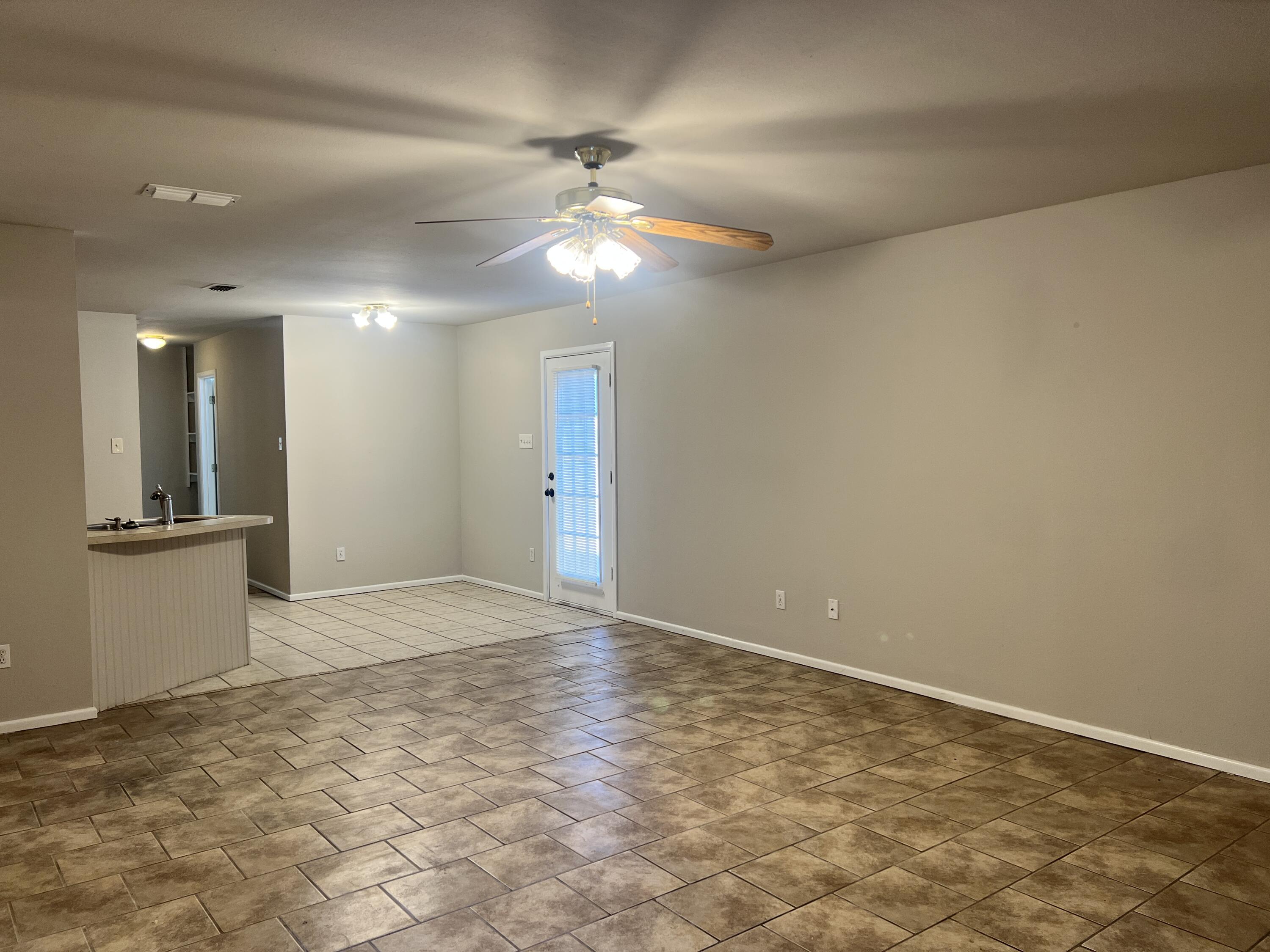 3415 49th Street, Unit B Lubbock, TX 79413 - Photo 2 of 17 a view of an empty room and kitchen view