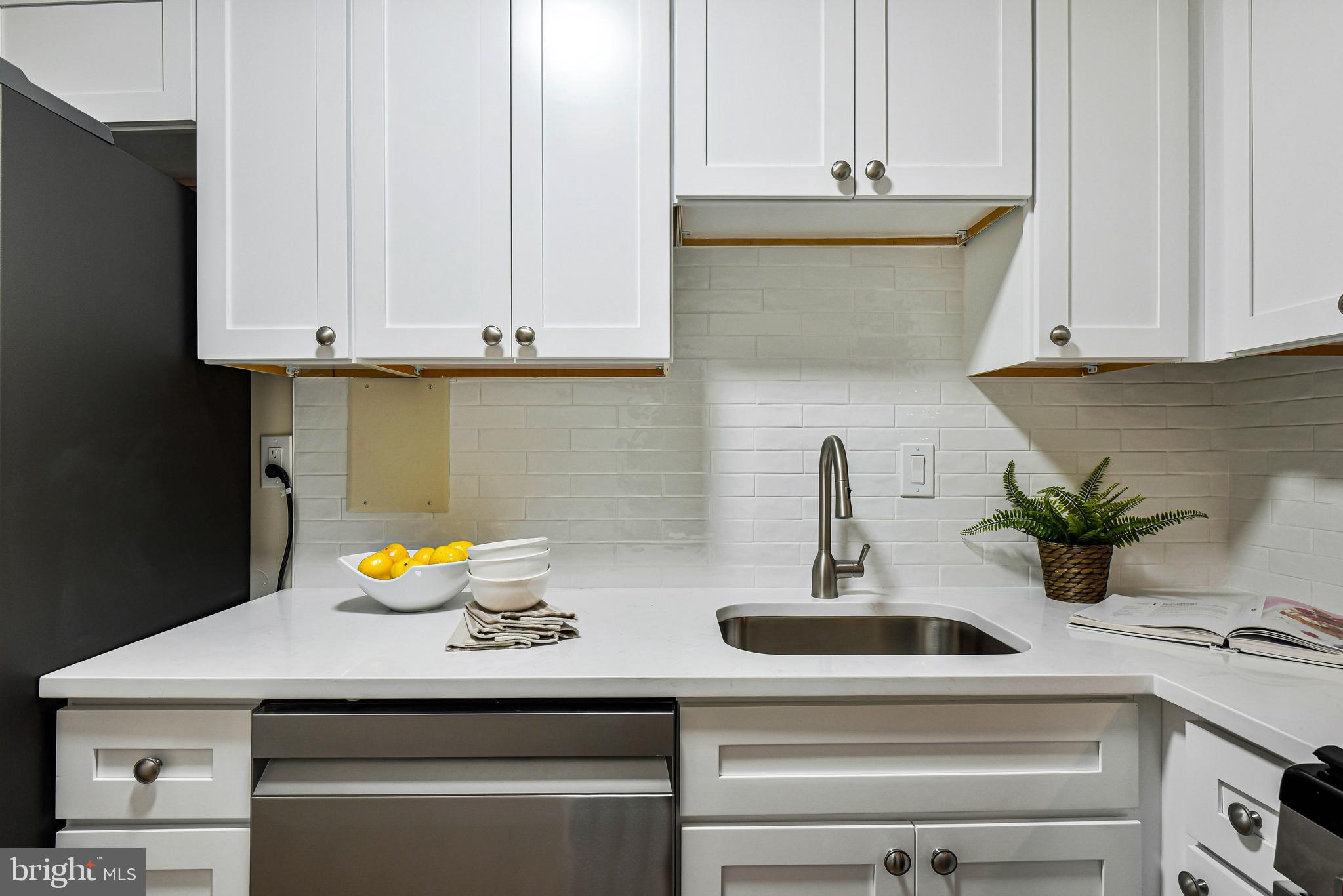 300 M Street Southwest, Unit N508 Washington, DC 20024 - Photo 11 of 32 a kitchen with stainless steel appliances granite countertop a sink and a white cabinets