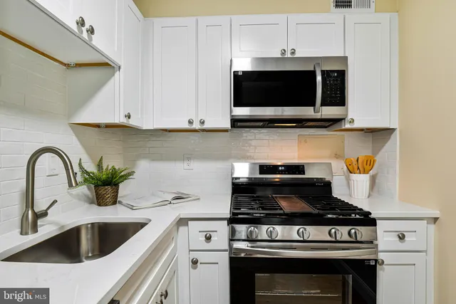 a kitchen with a stove and a microwave
