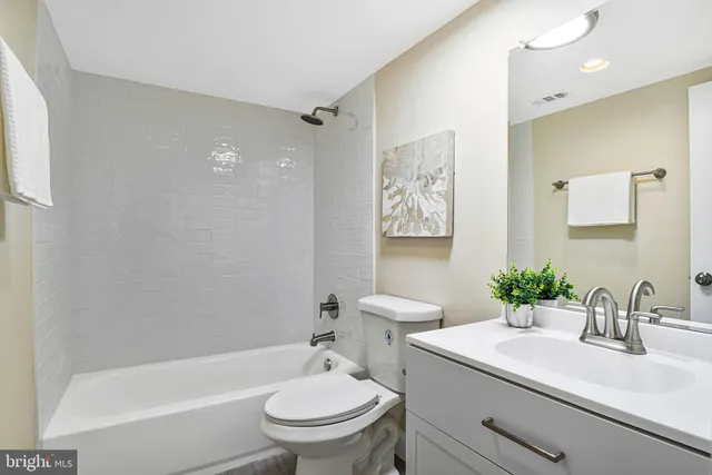 a bathroom with a sink toilet a mirror and shower