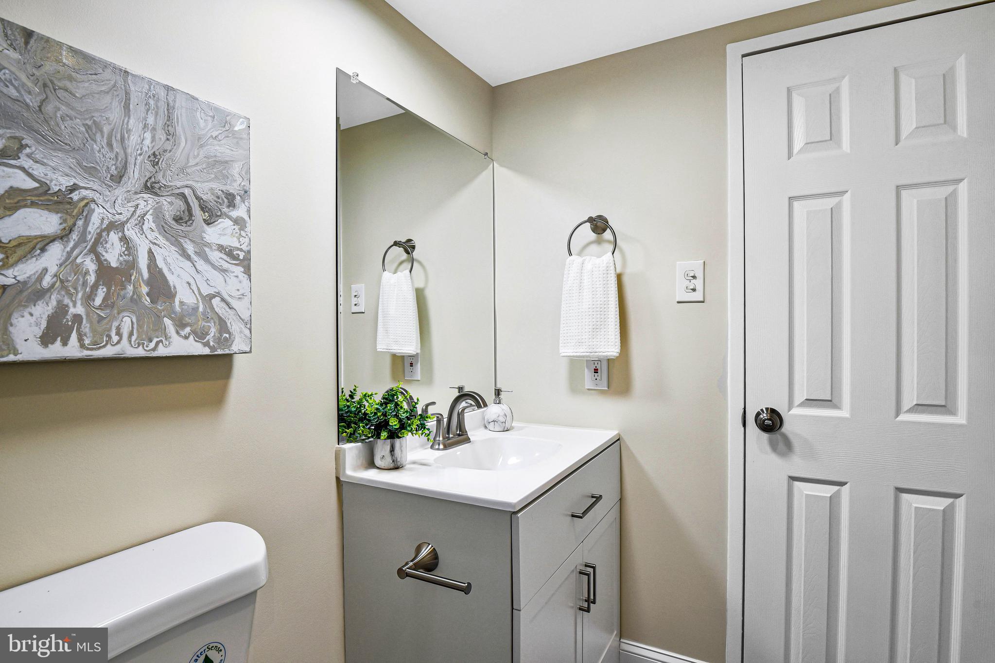 300 M Street Southwest, Unit N508 Washington, DC 20024 - Photo 14 of 32 a bathroom with a sink mirror vanity and toilet