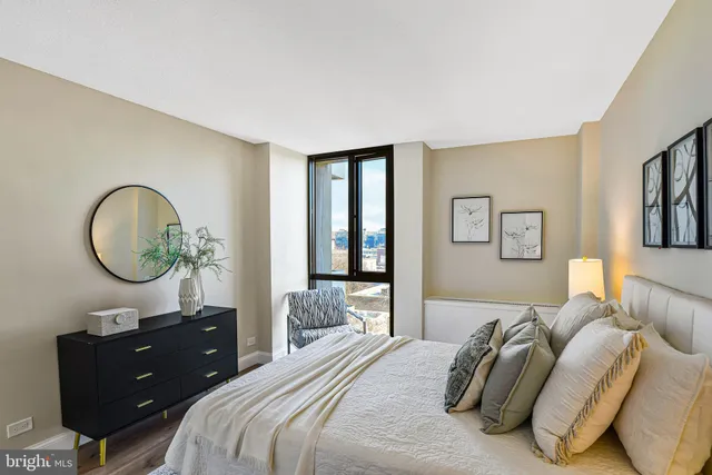 a bedroom with a bed and windows