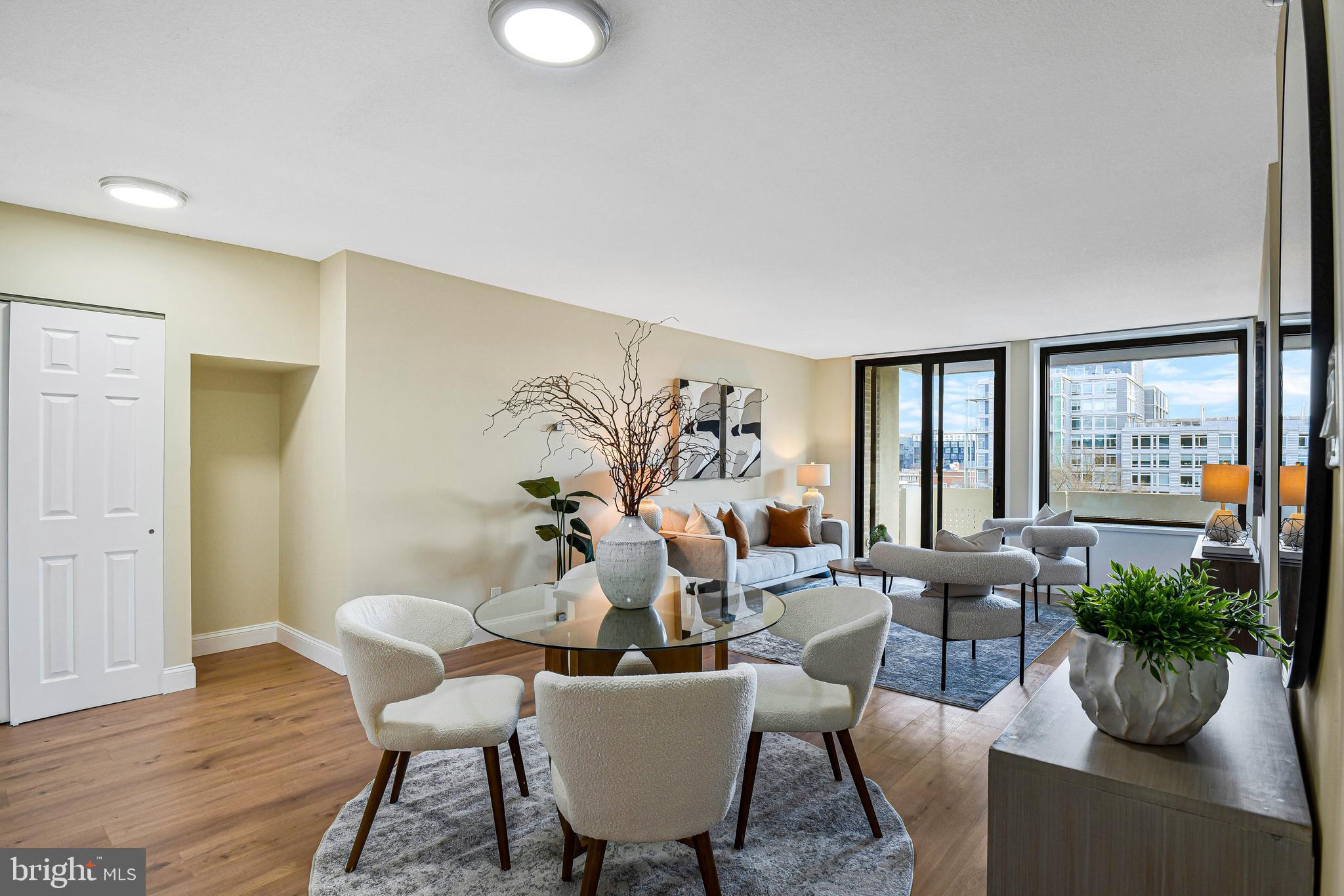 300 M Street Southwest, Unit N508 Washington, DC 20024 - Photo 2 of 32 a living room with furniture potted plant and a large window