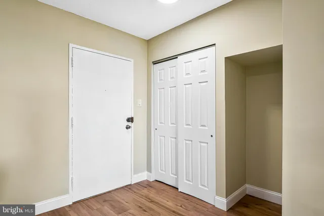 a view of a hallway with wooden floor