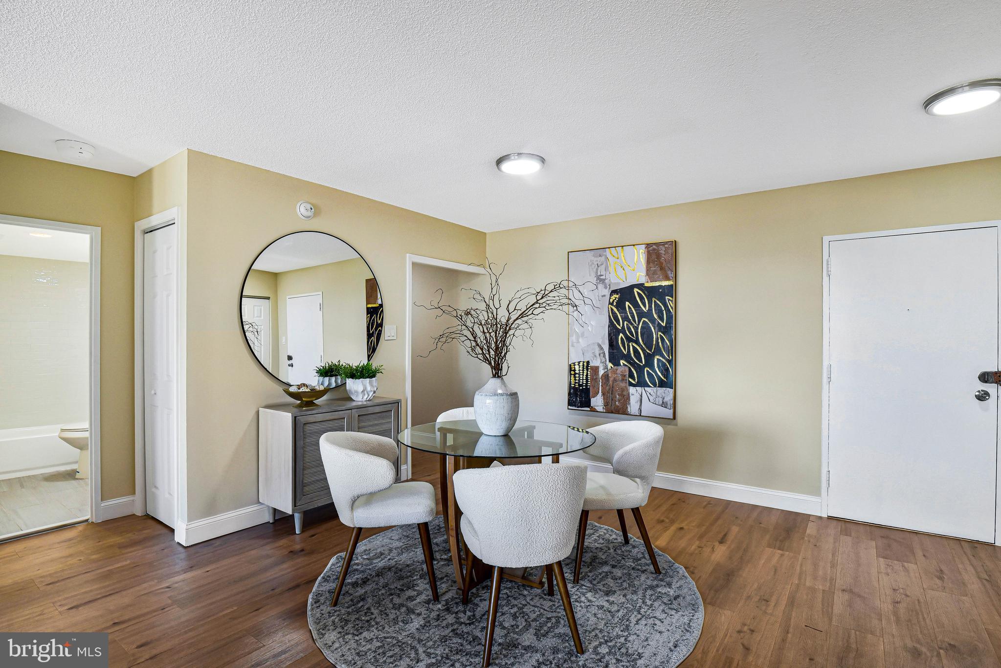 300 M Street Southwest, Unit N508 Washington, DC 20024 - Photo 4 of 32 a living room with furniture a mirror and a wooden floor