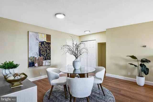 a dining room with furniture and wooden floor
