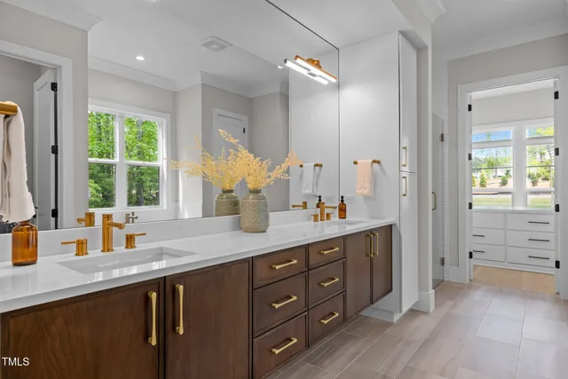 a bathroom with 2 sink and a mirror