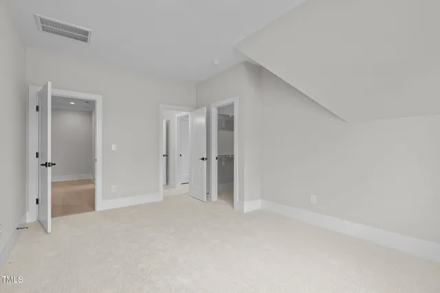 a view of a tennis ground with trees in the background