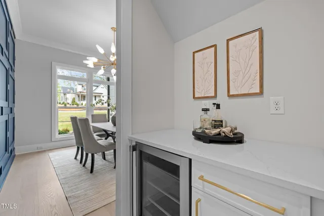 a kitchen with kitchen island a stove a table and chairs in it