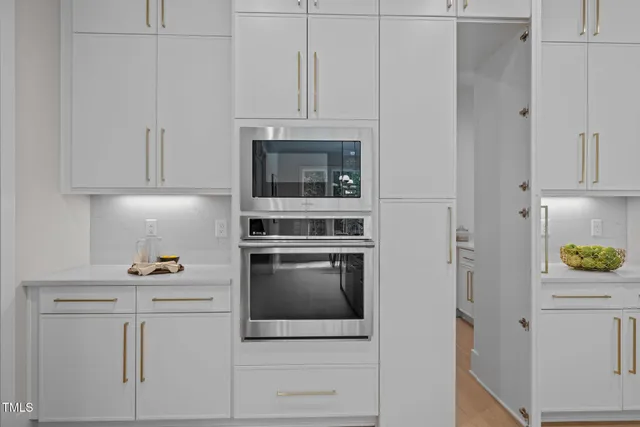a living room with furniture a fireplace and a large window