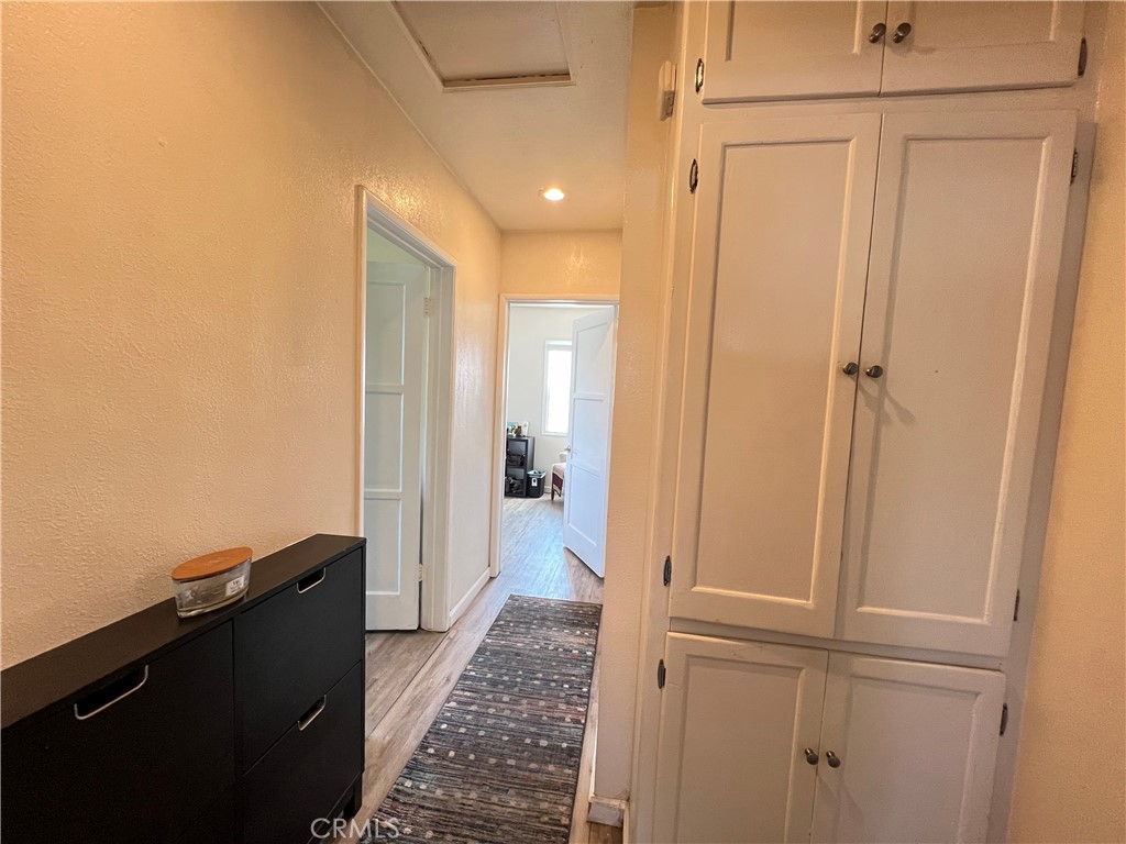 10709 Wheelock Circle Whittier, CA 90606 - Photo 15 of 34 a view of a hallway with wooden floor and a bathroom