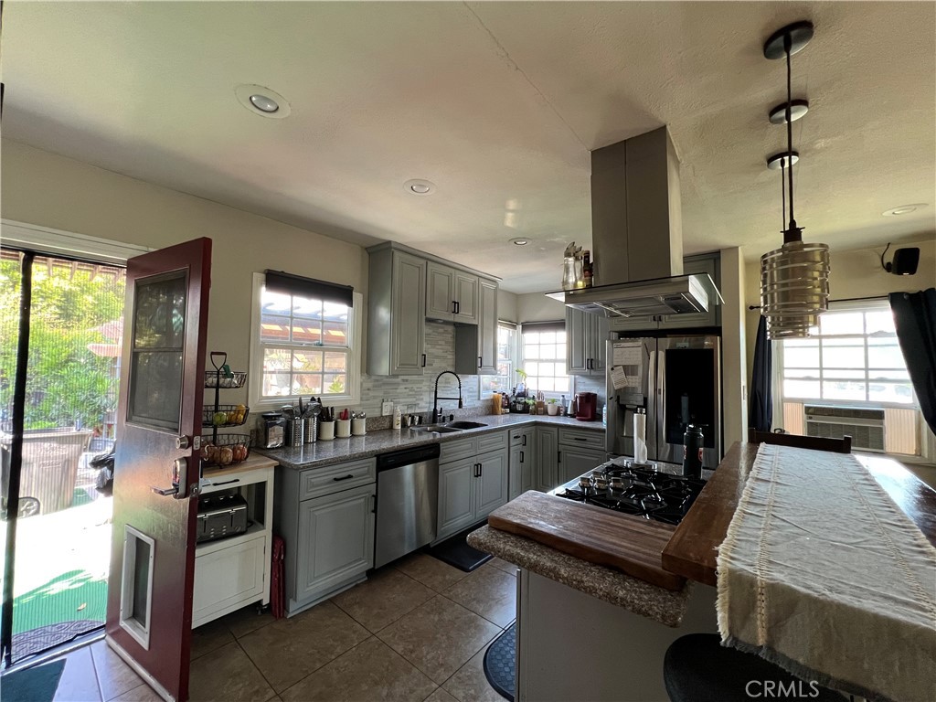 10709 Wheelock Circle Whittier, CA 90606 - Photo 20 of 34 a kitchen with lots of counter top space a stove and wooden floor