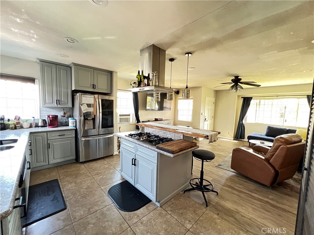 10709 Wheelock Circle Whittier, CA 90606 - Photo 24 of 34 a kitchen with kitchen island a counter top space a sink stainless steel appliances and cabinets