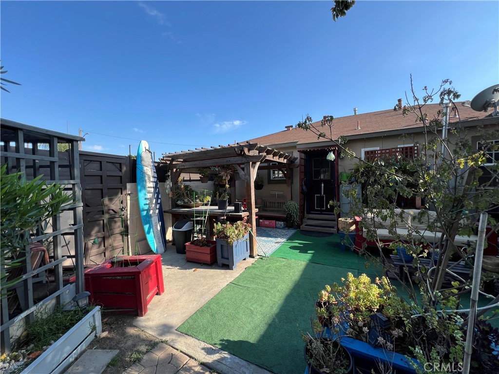 10709 Wheelock Circle Whittier, CA 90606 - Photo 28 of 34 a view of a patio with table and chairs potted plants with wooden fence