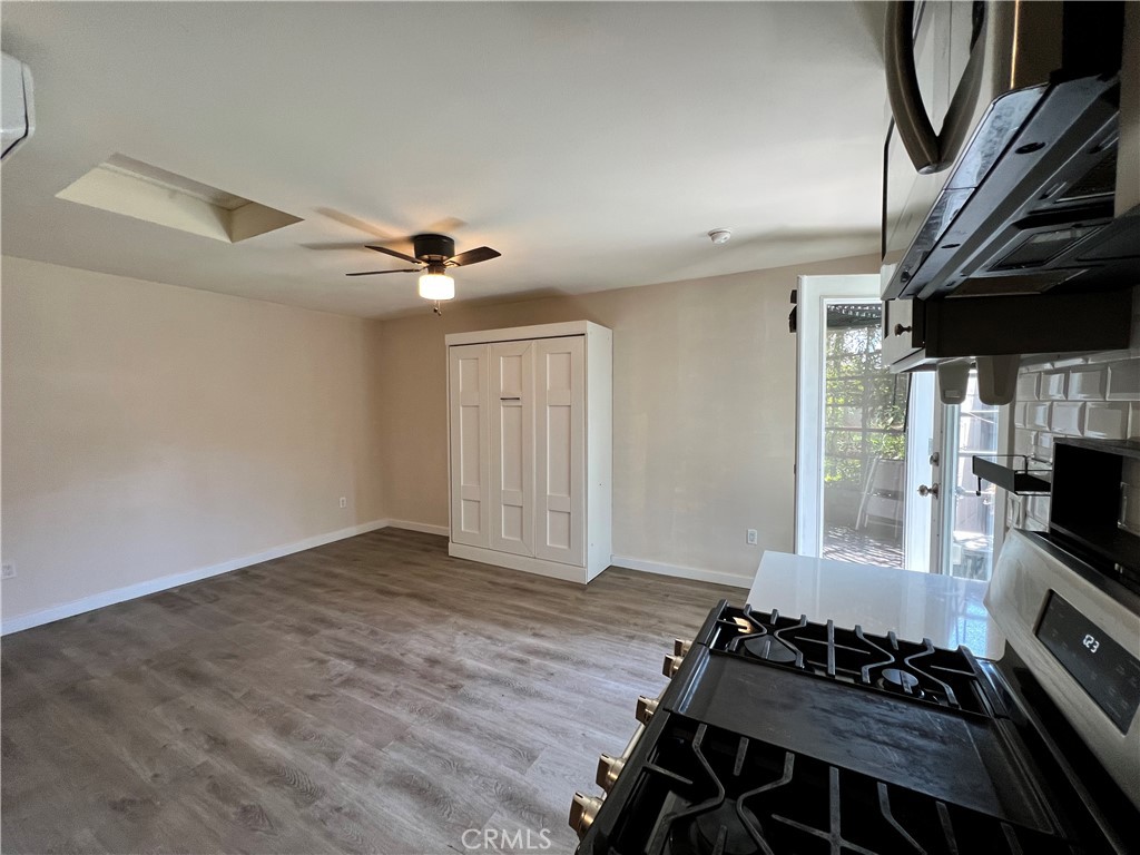 10709 Wheelock Circle Whittier, CA 90606 - Photo 4 of 34 a very nice looking room with wooden floor and a ceiling fan