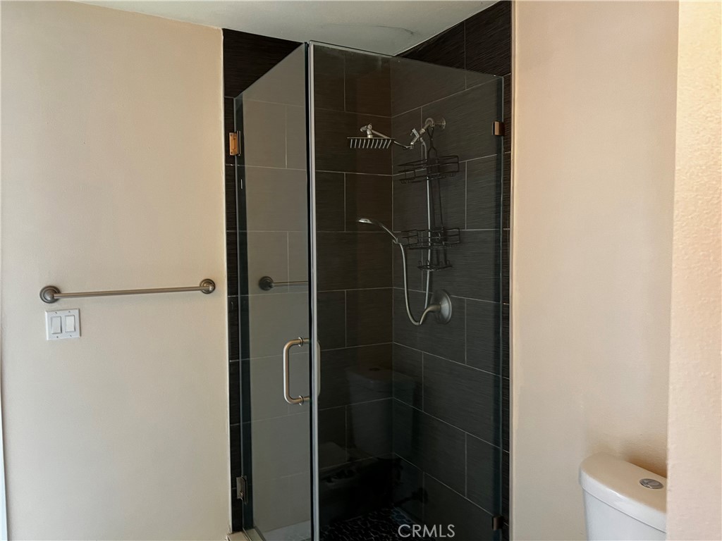 10709 Wheelock Circle Whittier, CA 90606 - Photo 6 of 34 a bathroom with a glass shower door