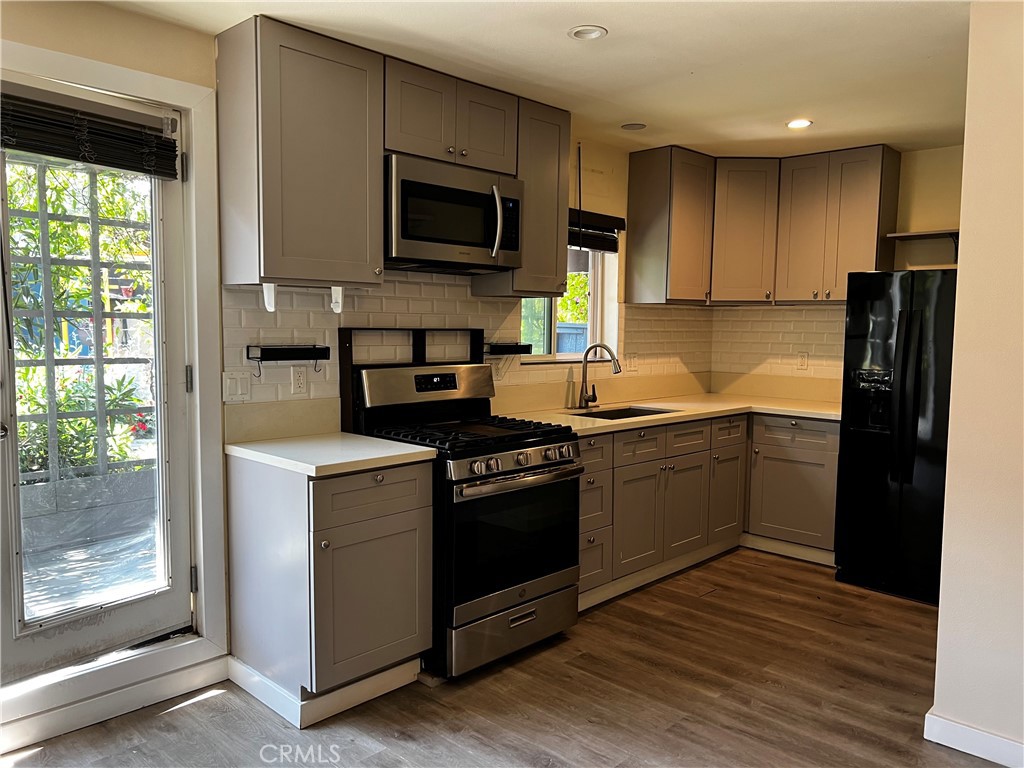 10709 Wheelock Circle Whittier, CA 90606 - Photo 8 of 34 a kitchen with a stove microwave and refrigerator
