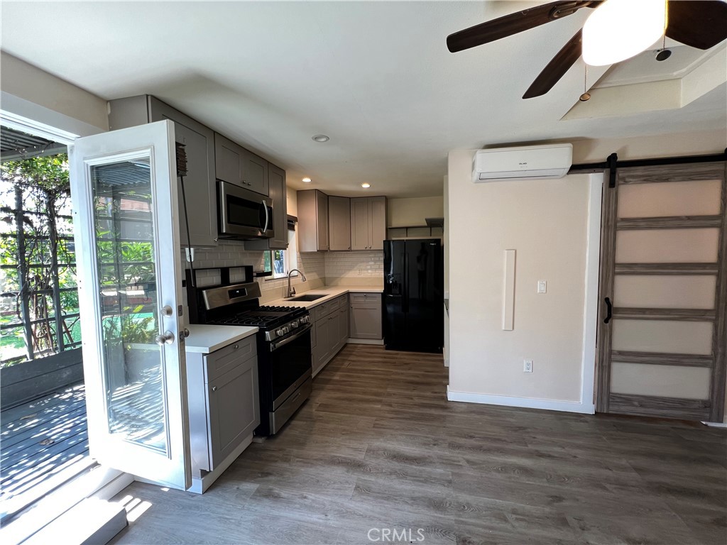 10709 Wheelock Circle Whittier, CA 90606 - Photo 9 of 34 a kitchen with granite countertop a refrigerator and a stove top oven