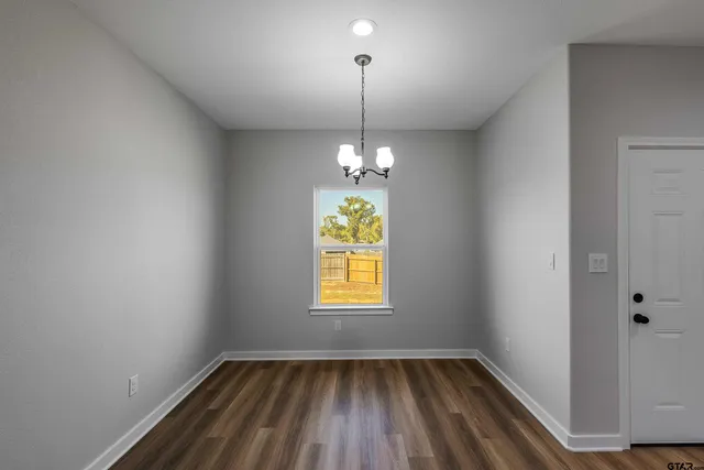 a hallway with window and wooden floor