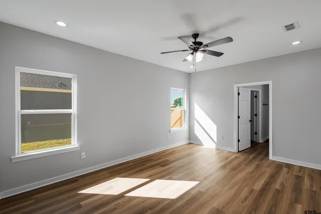 wooden floor in an empty room with a window
