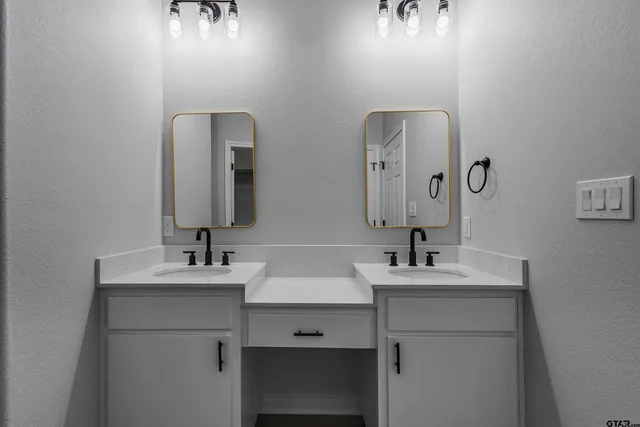a bathroom with a double vanity sink and mirror