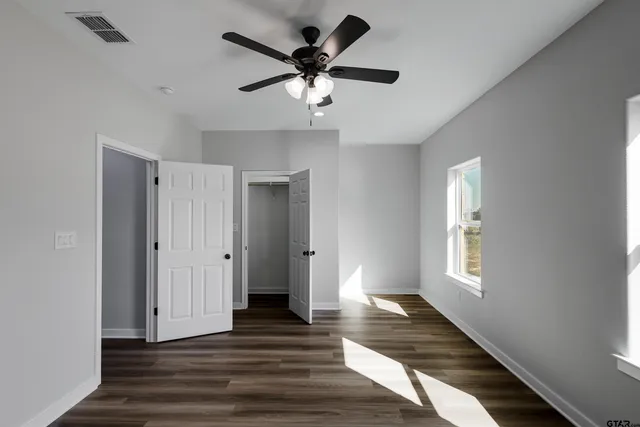 a view of hallway with wooden floor