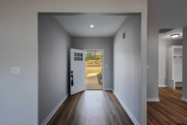 a view of a hallway with wooden floor