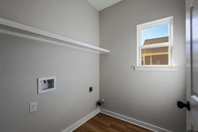 a view of a hallway with wooden floor and entryway