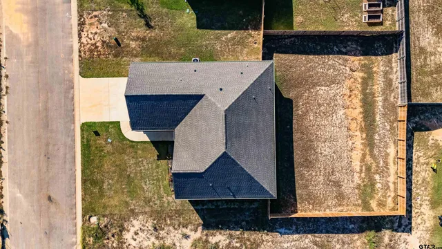 a aerial view of a house next to a yard with big yard