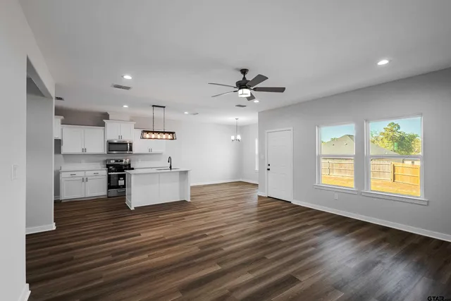 a view of kitchen with wooden floor and electronic appliances