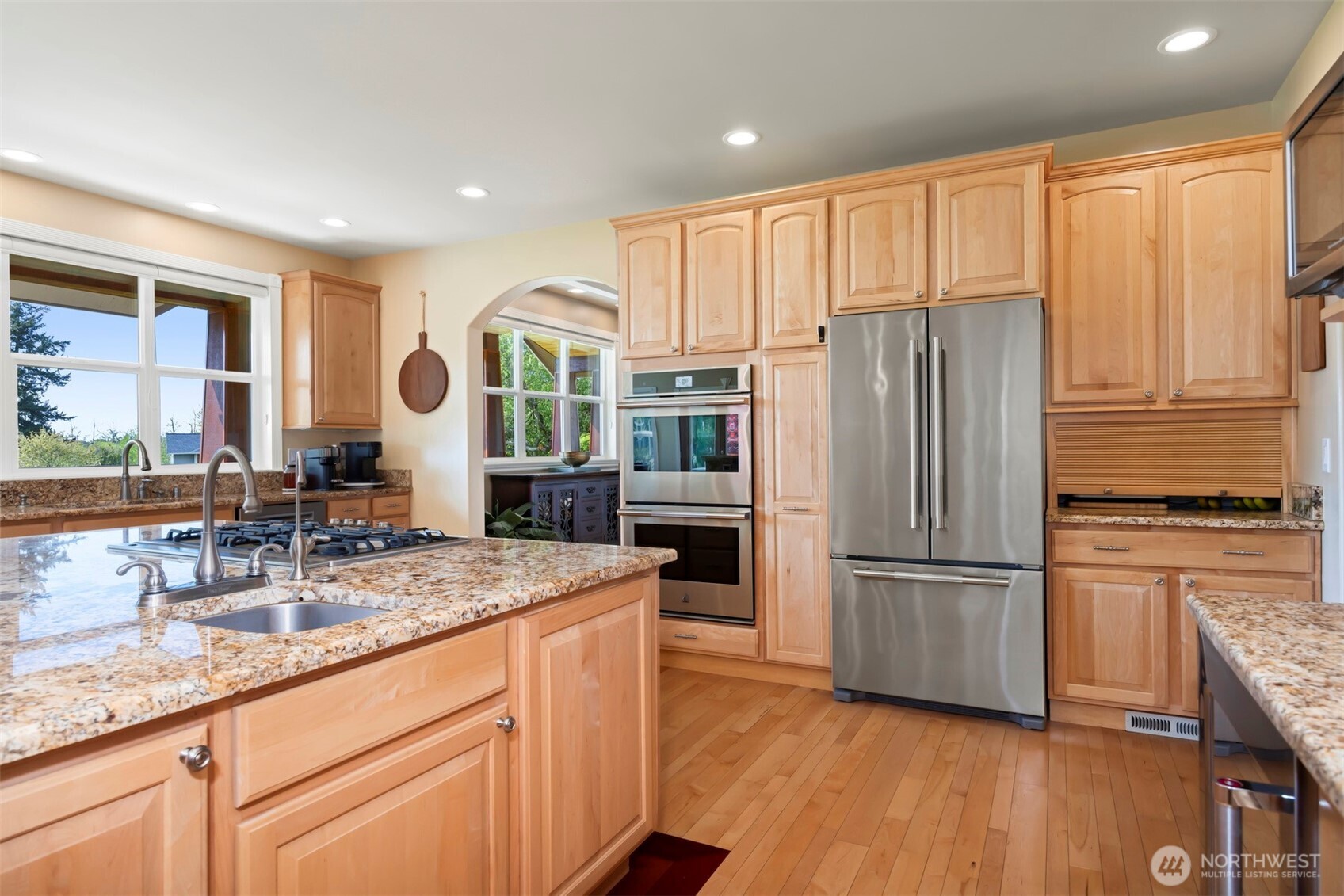 6152 Garrett Lane Ferndale, WA 98248 - Photo 14 of 40 a kitchen with stainless steel appliances granite countertop a refrigerator sink and cabinets