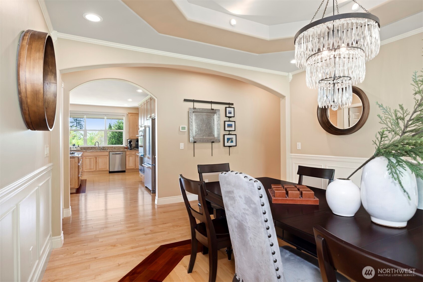 6152 Garrett Lane Ferndale, WA 98248 - Photo 22 of 40 a view of a dining room with furniture a chandelier and wooden floor